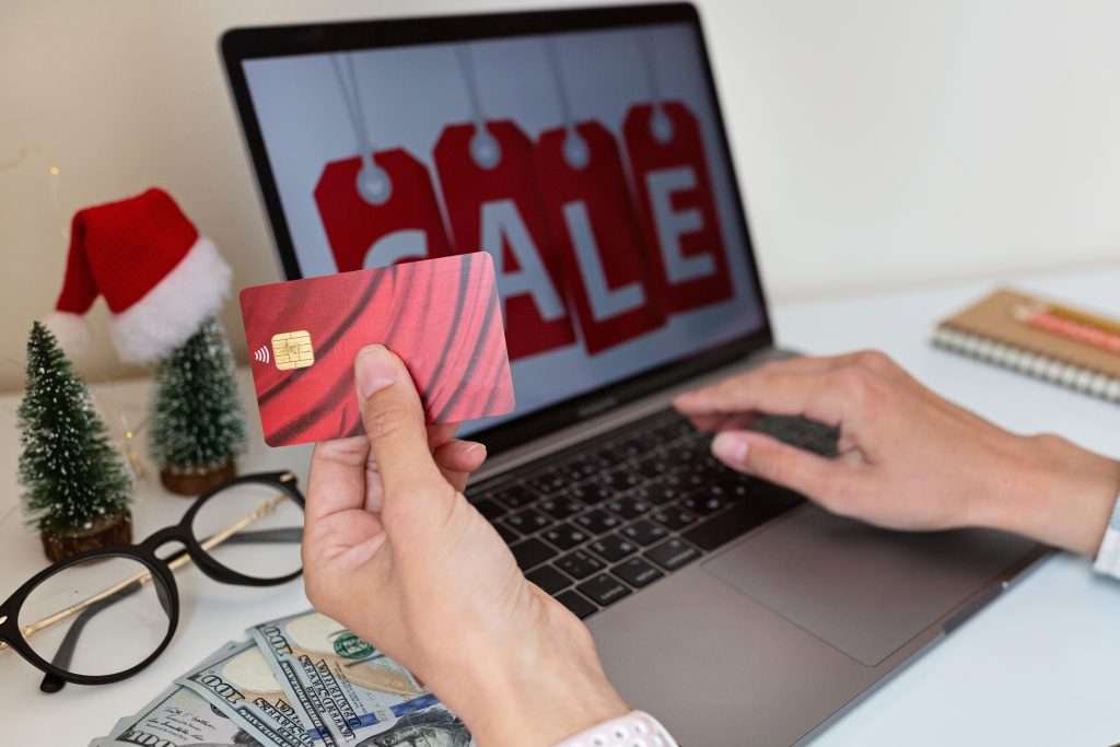 Woman holding a credit card while shopping online