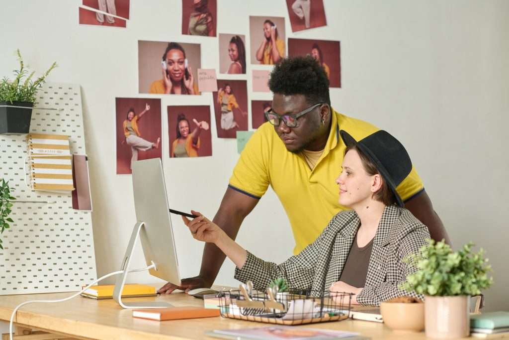 Creative team collaborating on a project at a desk